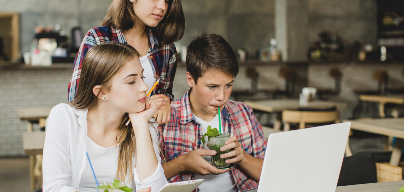 young-students-watching-laptop-together