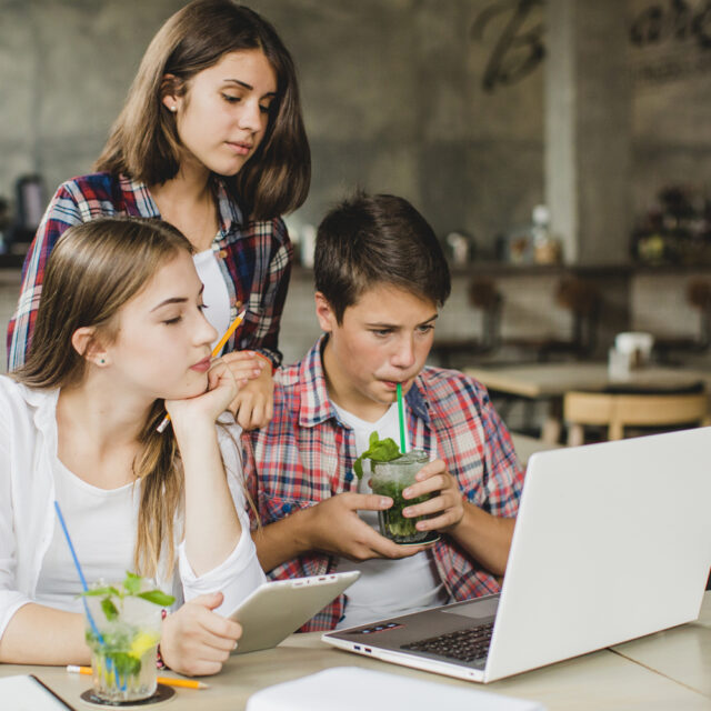 young-students-watching-laptop-together